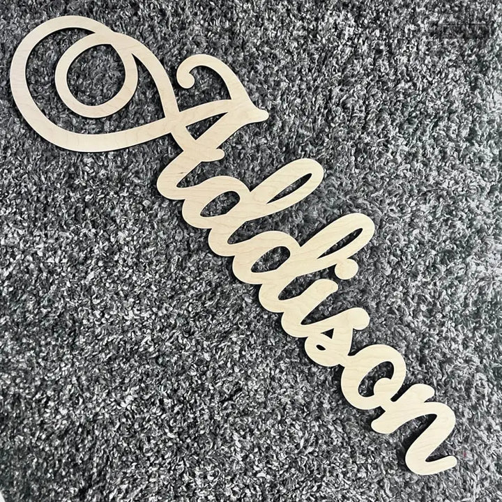 Laser cut wooden name sign for home decor and cutting boards in stylish design