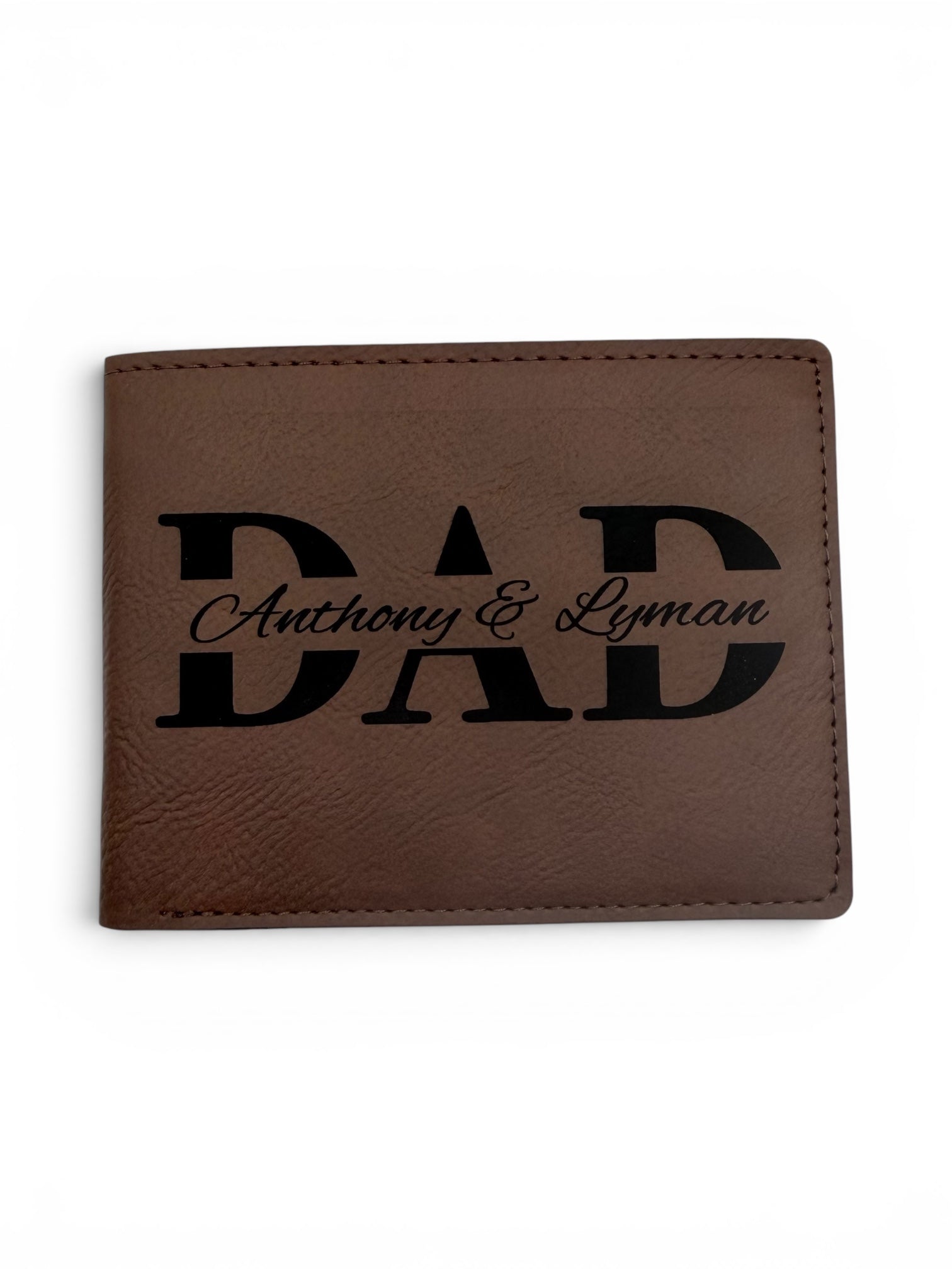 Brown leather wallet with 'DAD' engraving on a white background