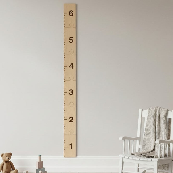 Puzzle-style laser-engraved wooden growth chart ruler assembled on nursery wall