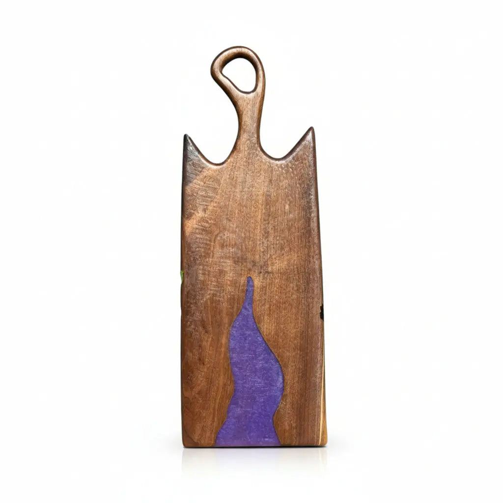 Wooden cutting board with purple inlay on a white background