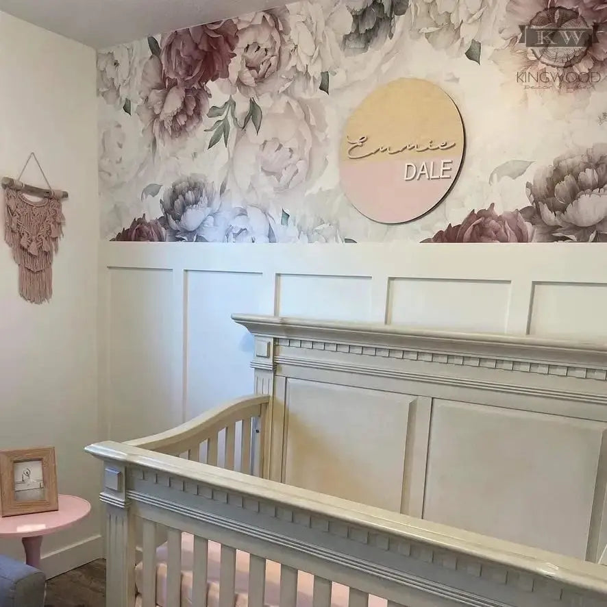 Rustic baby nursery with floral decor and a round name sign for personalized charm