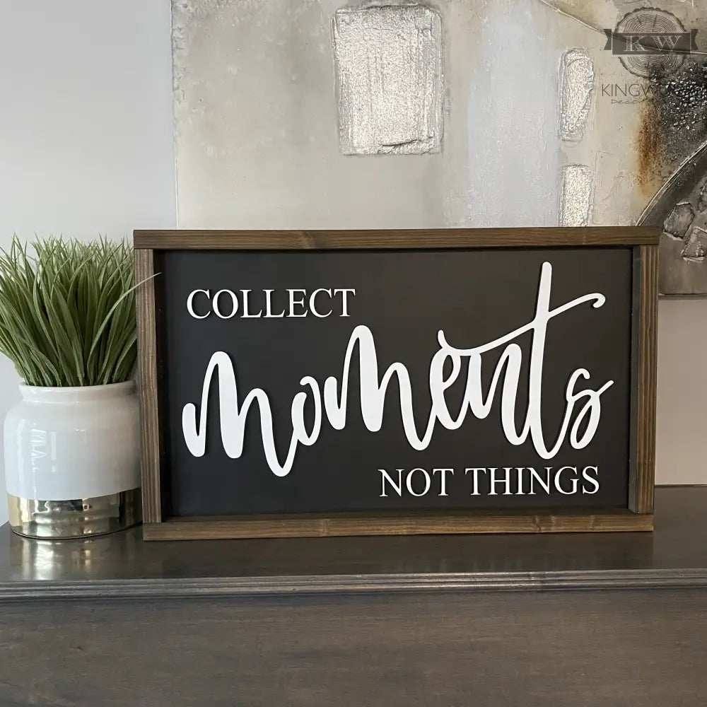 Framed Collect moments not things sign featuring laser cut words on wooden background
