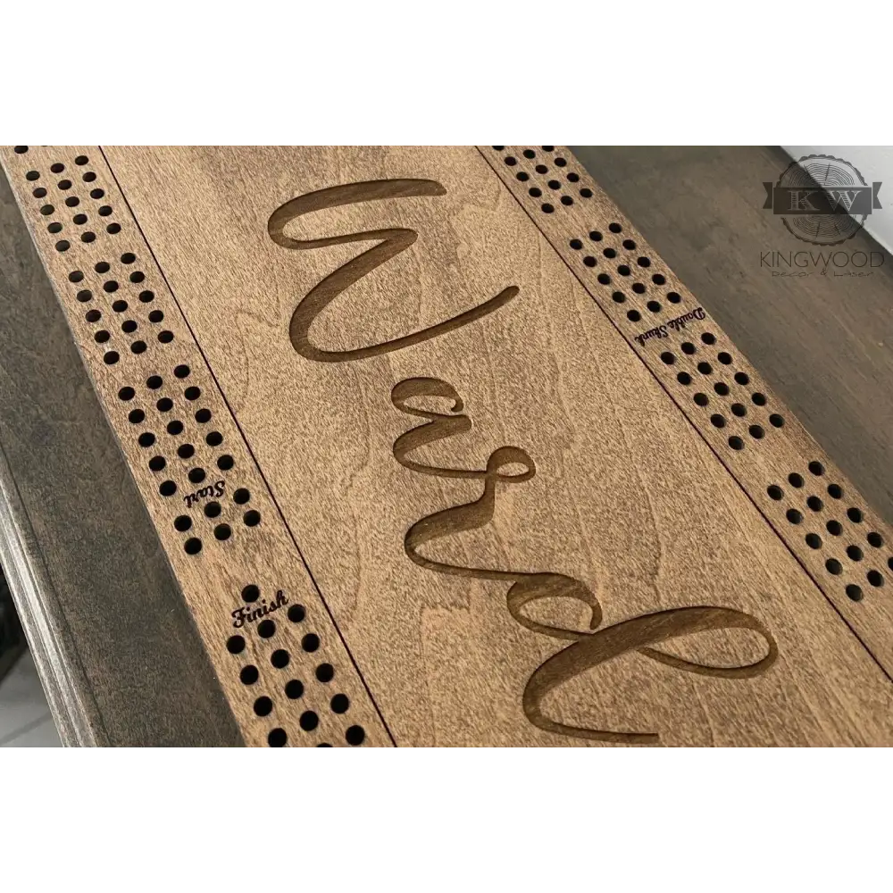 Personalized Baltic Birch cribbage board with engraved name, storage compartment, and metal pegs