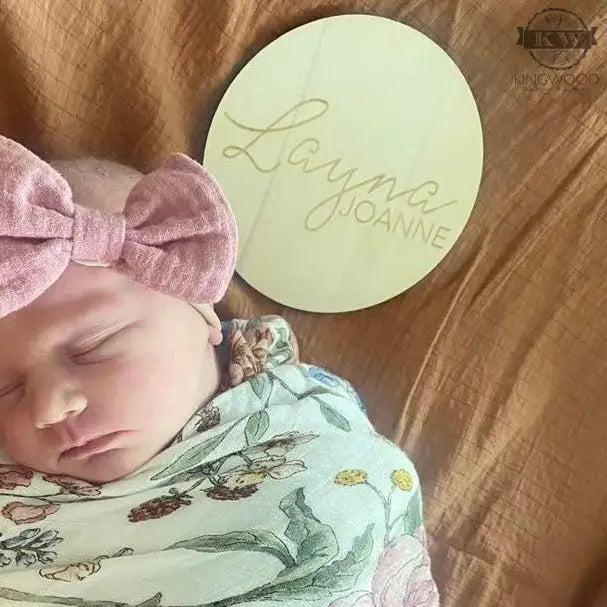 Natural birchwood baby name announcement plaque showcasing unique grain design suitable for cutting boards