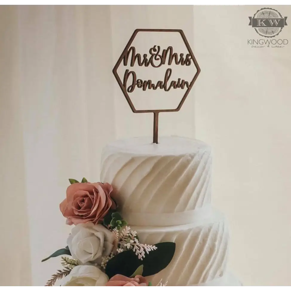 Elegant wedding cake with floral decorations and custom cake topper design