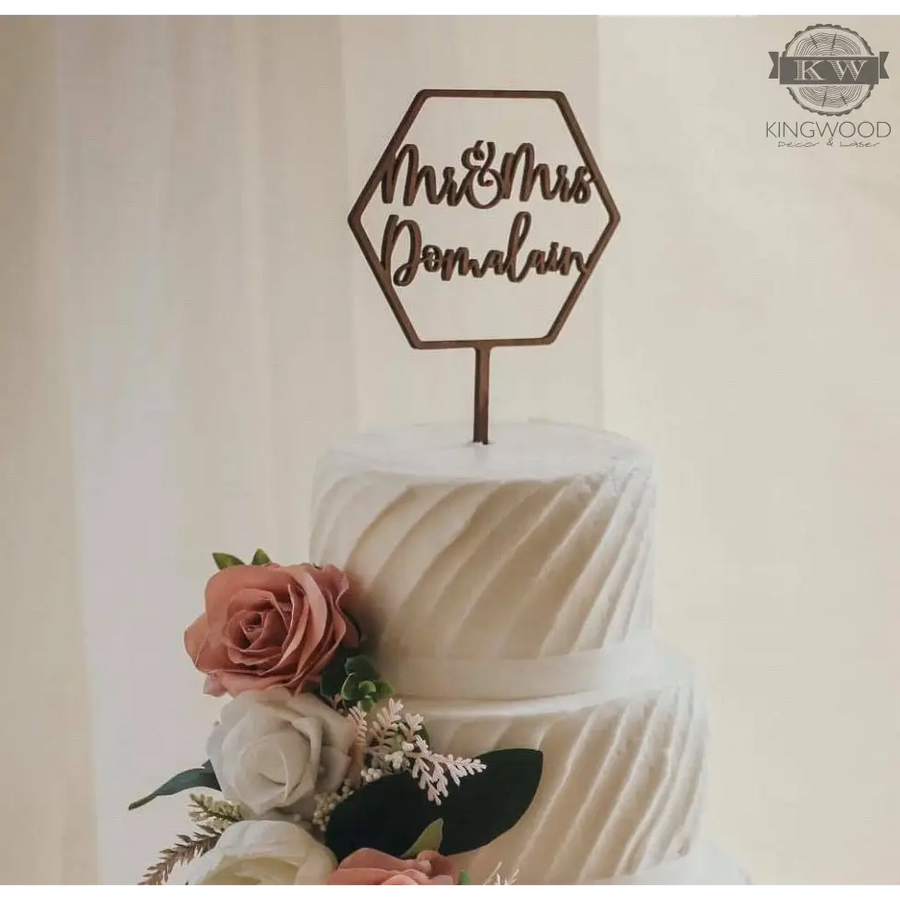 Elegant wedding cake with floral decorations and custom cake topper design