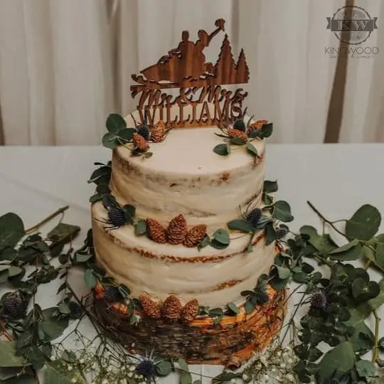 Two-tiered wedding cake with custom wedding cake topper and wooden design