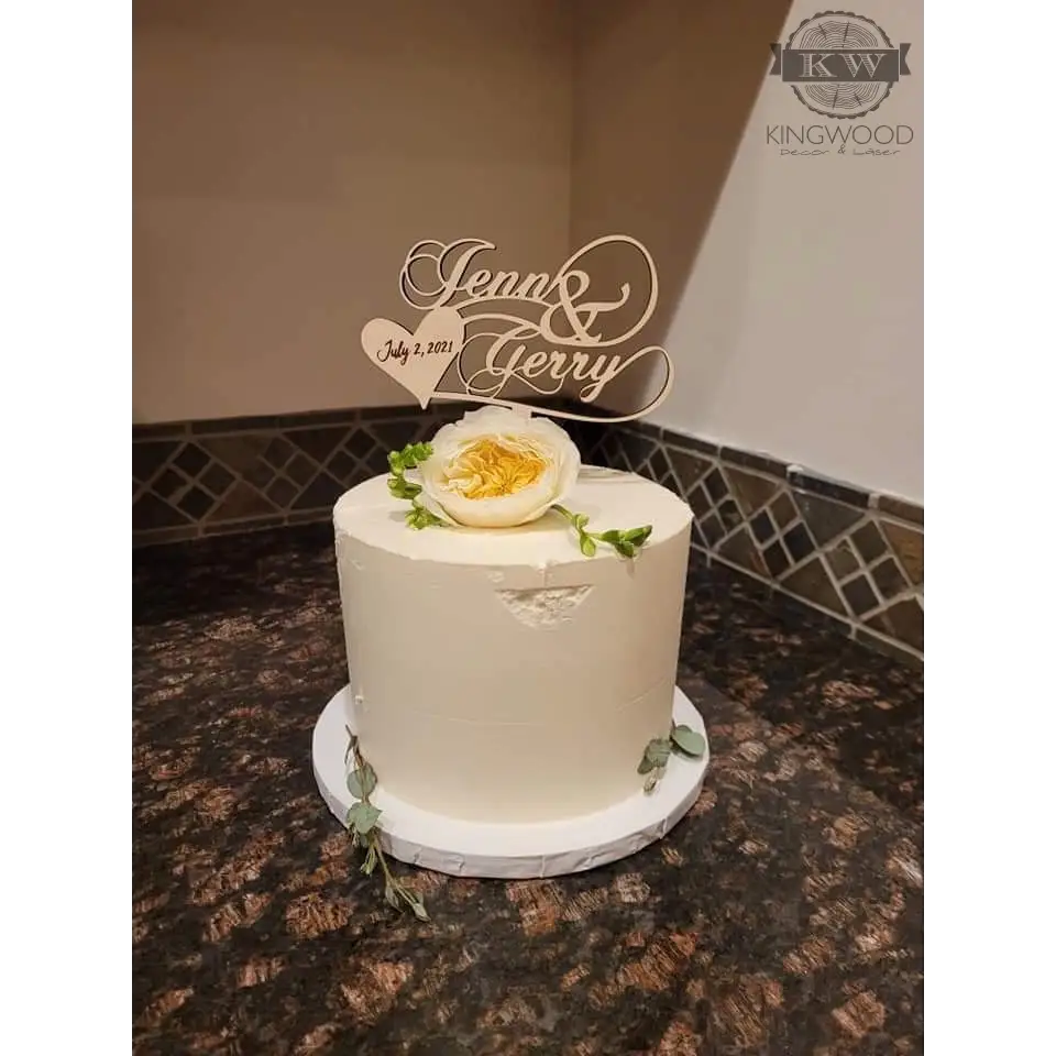 White frosted wedding cake topper with floral designs and personalized topper for wedding cake