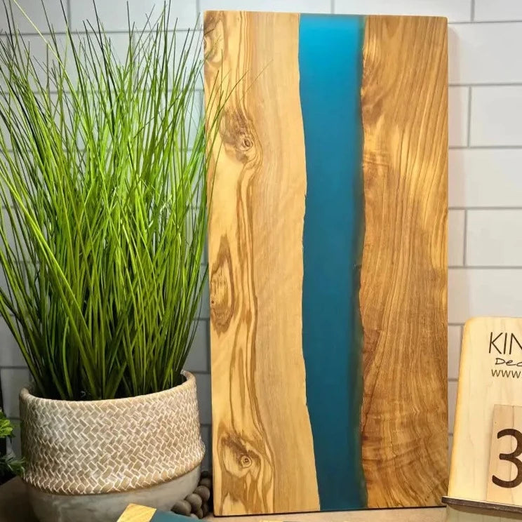 Olive wood epoxy river charcuterie board with blue resin river for elegant presentation