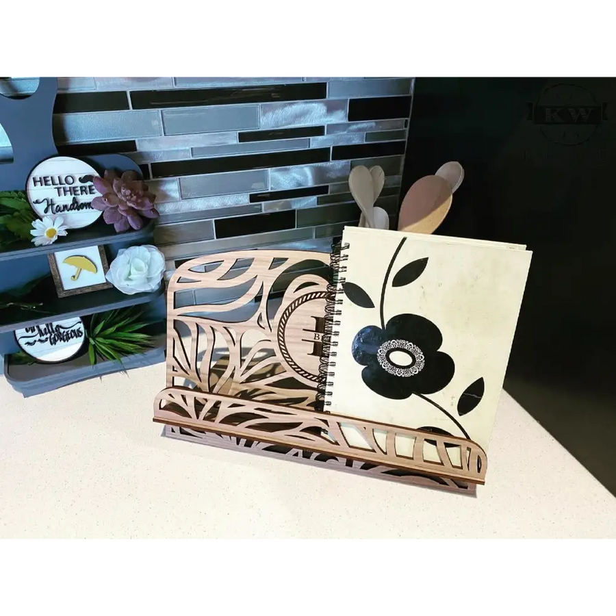 Laser-cut wooden homestyle book stand with notebook, ideal as a recipe stand or cutting board holder