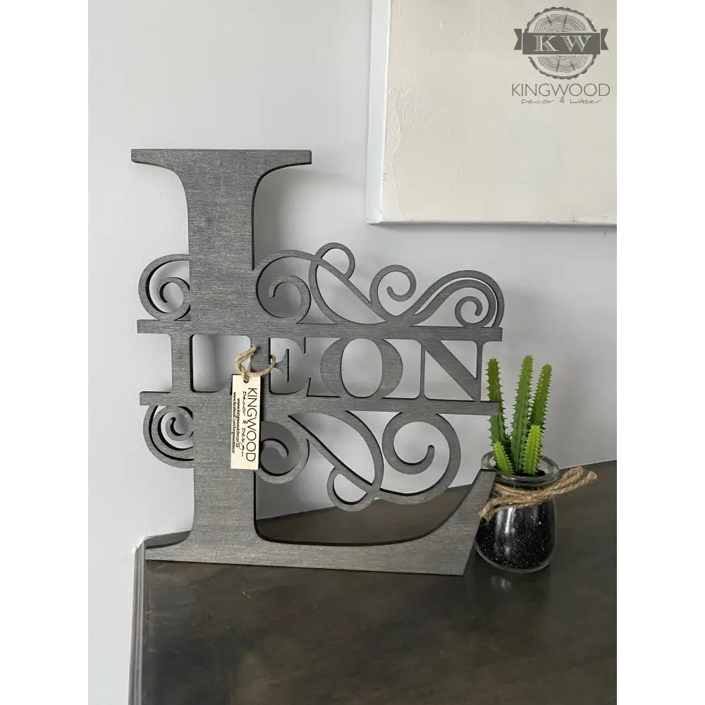 Gray wooden letter L with decorative name cutout for large family monogram signs