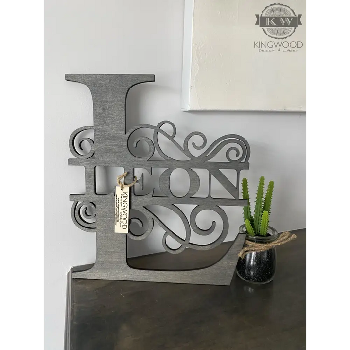 Gray wooden letter L with decorative name cutout for large family monogram signs