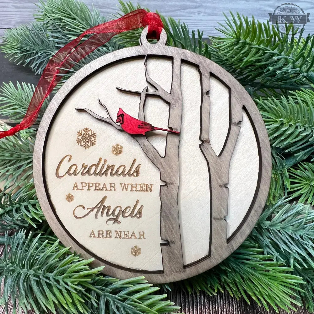 Round wooden memorial cardinal ornament for remembrance decor featuring laser engraving