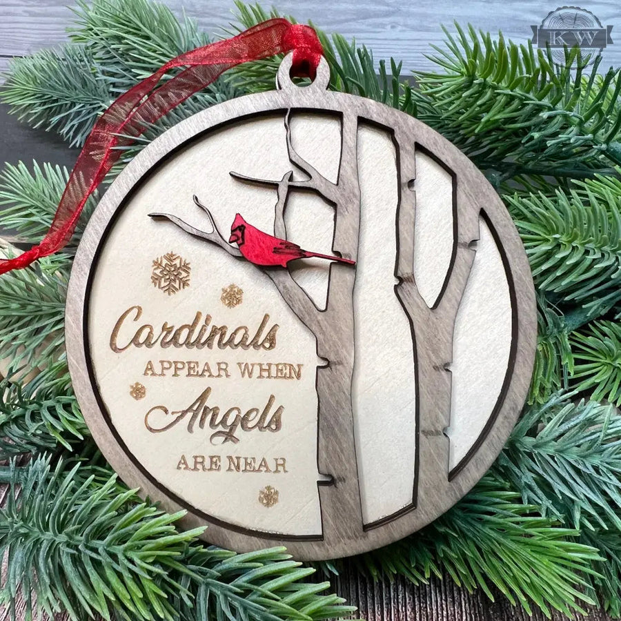 Round wooden memorial cardinal ornament for remembrance decor featuring laser engraving