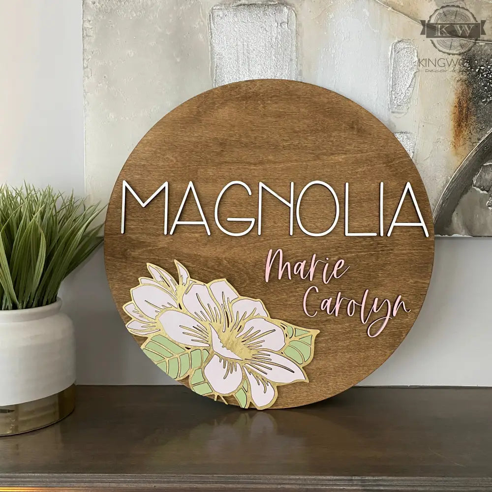 Wooden nursery round sign with magnolia flower design, ideal for decorative cutting boards