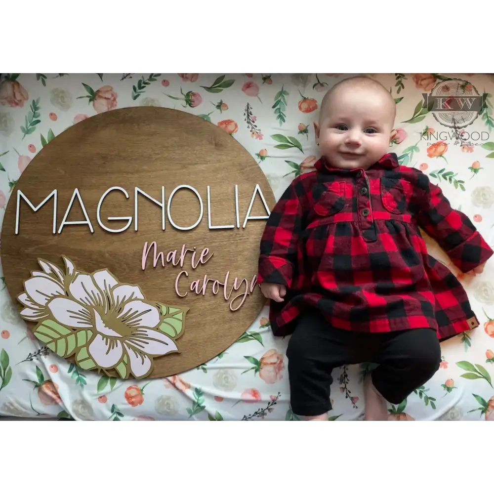 Nursery round sign with magnolia flower design and wooden name accent for decoration