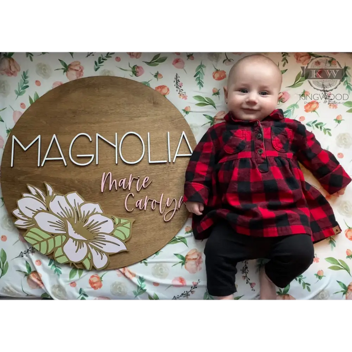 Nursery round sign with magnolia flower design and wooden name accent for decoration
