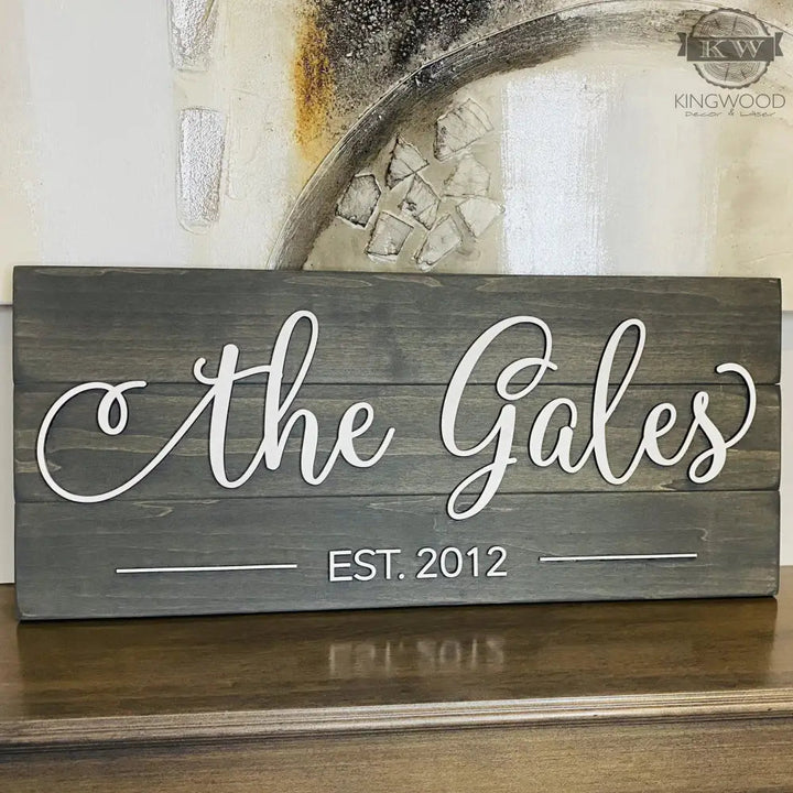 Gray wooden family name sign as personalized family decor with laser-cut Est Date