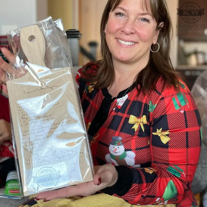 Wrapped wooden cutting board featuring personalized handwritten recipe engraving for a unique kitchen gift