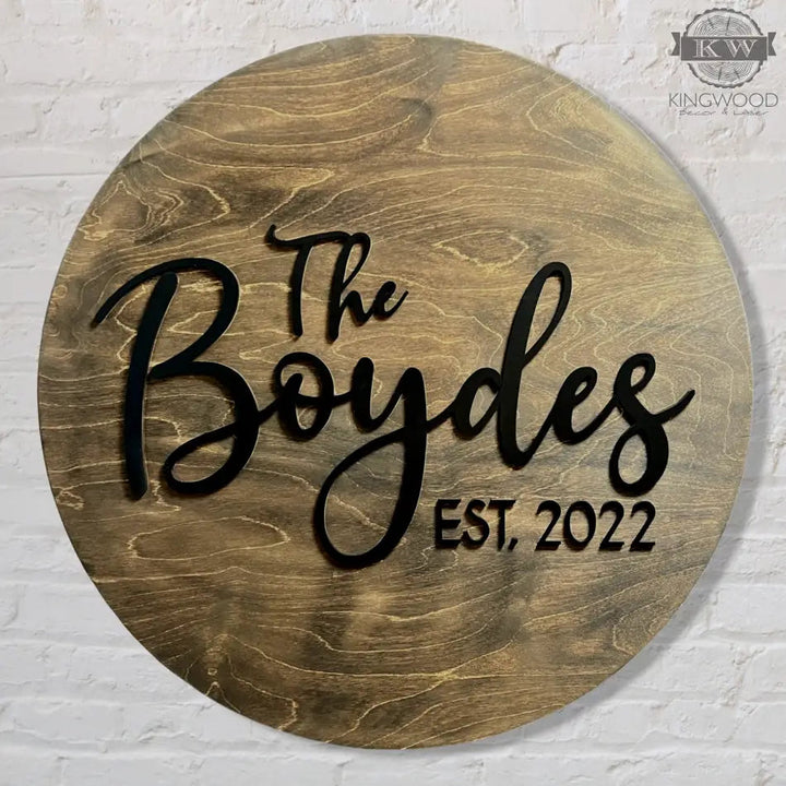 Round wooden wedding guest signing board with black lettering for sign guestbook use