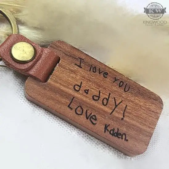 Engraved wooden keychain with custom handwriting and leather detail, perfect for personalized accessories