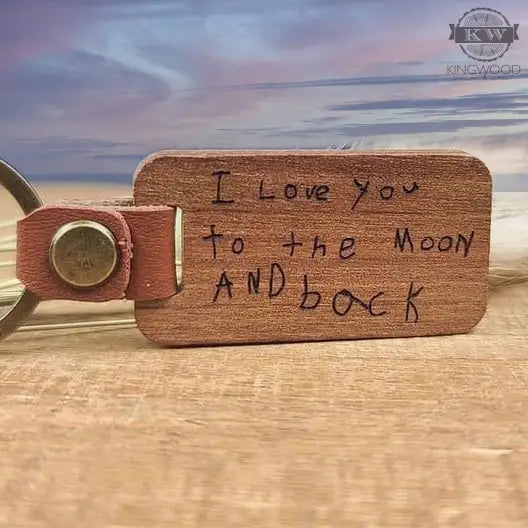 Wooden keychains custom engraved with handwriting and leather detail for personalized accessories
