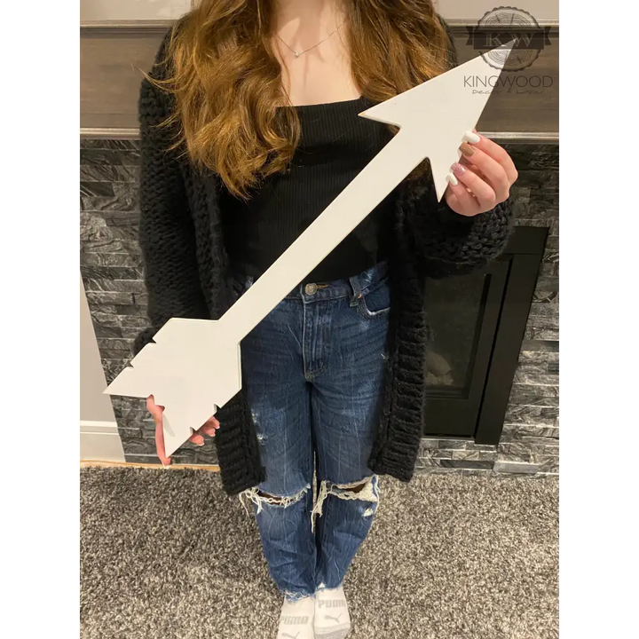 White wooden arrow used as rustic decor in multiple sizes, ideal for home or cutting boards